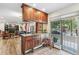 Kitchen featuring wood cabinets, a breakfast bar, tile flooring, stainless appliances and open access to the living room at 1200 N Humboldt St # 101, Denver, CO 80218