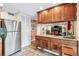 Well-equipped kitchen with stainless appliances, wood cabinets, access to pantry storage, and granite counters at 1200 N Humboldt St # 101, Denver, CO 80218