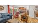 Cozy living room featuring hardwood floors, a blue sofa, craftsman-style furniture and an adjacent kitchen at 1200 N Humboldt St # 101, Denver, CO 80218