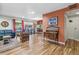 Open-concept living space with hardwood floors seamlessly connecting to the dining area and kitchen at 1200 N Humboldt St # 101, Denver, CO 80218