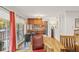 Open-concept living room with hardwood floors, craftsman-style seating, and a view of the kitchen and balcony at 1200 N Humboldt St # 101, Denver, CO 80218