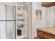 Bright kitchen pantry featuring built-in shelving stocked with various household items and a stainless steel refrigerator at 1200 N Humboldt St # 101, Denver, CO 80218