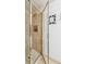 Modern shower showcasing tan tiles, glass door, and decorative accent, creating a clean and contemporary bathroom experience at 1200 N Humboldt St # 101, Denver, CO 80218
