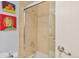 Tiled shower with glass door and updated fixtures, plus colorful wall art at 1200 N Humboldt St # 101, Denver, CO 80218