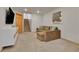 Cozy basement with comfortable sofa, TV, and staircase at 5394 S Gray St, Littleton, CO 80123