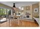 Dining area with wood floors, access to deck, and an open view of the living room at 5394 S Gray St, Littleton, CO 80123