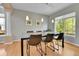 Dining room with hardwood floors and large windows that overlook an exterior green space at 5394 S Gray St, Littleton, CO 80123