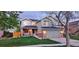 Inviting two-story home features landscape lighting and a well-manicured lawn at 5394 S Gray St, Littleton, CO 80123