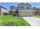 Inviting two-story home features a well-manicured lawn and attached two-car garage at 5394 S Gray St, Littleton, CO 80123
