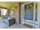 Charming front porch features comfortable seating and a decorative wreath on the front door at 5394 S Gray St, Littleton, CO 80123