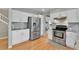 Well-appointed kitchen with stainless steel appliances, subway tile backsplash, and white cabinetry at 5394 S Gray St, Littleton, CO 80123