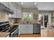 Updated kitchen with white cabinets, stainless appliances, granite countertops, and wood floors at 5394 S Gray St, Littleton, CO 80123