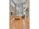 Open living room with vaulted ceiling, hardwood floors, and an abundance of natural light at 5394 S Gray St, Littleton, CO 80123