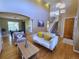 Open-concept living area with hardwood floors connecting the living room and dining area at 5394 S Gray St, Littleton, CO 80123