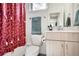 Well-lit bathroom featuring a shower with unique curtain and modern fixtures at 8711 E Hampden Ave # 26, Denver, CO 80231
