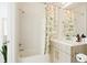 Bathroom featuring a shower-tub combination, vanity, decorative mirror, and floral shower curtain at 8711 E Hampden Ave # 26, Denver, CO 80231