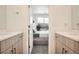 Bright bathroom featuring dual sinks and a view into a sunlit bedroom at 8711 E Hampden Ave # 26, Denver, CO 80231