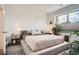 Bright bedroom featuring a large window, modern decor, and a cozy bed at 8711 E Hampden Ave # 26, Denver, CO 80231