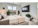 Bedroom featuring a large window, a mounted tv, and modern decor at 8711 E Hampden Ave # 26, Denver, CO 80231