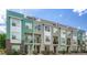 Attractive townhome row with varied colors and modern design elements under a blue sky at 8711 E Hampden Ave # 26, Denver, CO 80231