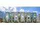Street view of modern townhomes with balconies and varied exterior finishes under a cloudy sky at 8711 E Hampden Ave # 26, Denver, CO 80231