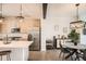 Well-lit kitchen featuring stainless steel appliances, an island, and a dining area at 8711 E Hampden Ave # 26, Denver, CO 80231