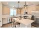 Modern kitchen with stainless steel appliances, a kitchen island, and stylish lighting at 8711 E Hampden Ave # 26, Denver, CO 80231
