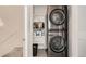 Convenient laundry room with a stacked washer and dryer, plus shelving at 8711 E Hampden Ave # 26, Denver, CO 80231