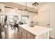 Bright, open-concept living area with hardwood floors and contemporary light fixtures at 8711 E Hampden Ave # 26, Denver, CO 80231