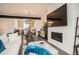 Stylish living area with modern fireplace, media console, open layout, and dining area at 8711 E Hampden Ave # 26, Denver, CO 80231