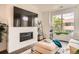 Inviting living area featuring fireplace, large window, and modern decor at 8711 E Hampden Ave # 26, Denver, CO 80231