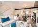 Bright living room with an open layout, a cozy sofa, and a modern dining area at 8711 E Hampden Ave # 26, Denver, CO 80231