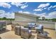 Inviting rooftop patio with wicker furniture and blue cushions under a bright sky at 8711 E Hampden Ave # 26, Denver, CO 80231