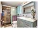 Nicely appointed bathroom featuring a shower and a decorative vanity with a white countertop at 12183 W Cross Dr # 202, Littleton, CO 80127