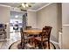Cozy dining area features a round wooden table, patterned chairs, and stylish decor, adjacent to the kitchen at 12183 W Cross Dr # 202, Littleton, CO 80127