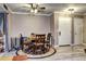 Cozy dining area featuring a round table with chairs and a ceiling fan, adjacent to a white-door entryway at 12183 W Cross Dr # 202, Littleton, CO 80127