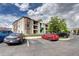 Apartment building exterior with well-maintained landscaping and ample parking at 12183 W Cross Dr # 202, Littleton, CO 80127