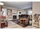 Spacious living room featuring a fireplace with stone accents, built-in shelves, and comfortable seating at 12183 W Cross Dr # 202, Littleton, CO 80127