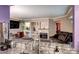 Open-concept space with stone fireplace, built-in shelves, and bar seating, creating a cozy and inviting atmosphere at 12183 W Cross Dr # 202, Littleton, CO 80127