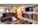 Inviting living area with fireplace, built-in shelves, modern finishes, seamlessly flows into dining and kitchen at 12183 W Cross Dr # 202, Littleton, CO 80127