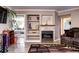 Inviting living room with a decorative fireplace, built-in shelving, comfortable seating, and wood-style flooring at 12183 W Cross Dr # 202, Littleton, CO 80127