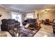 Comfortable living room showcasing a seating area and leading to a cozy dining space, featuring luxury flooring at 12183 W Cross Dr # 202, Littleton, CO 80127