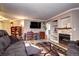 Cozy living room with a stone fireplace, built-in shelves, comfortable seating, and wood-look flooring at 12183 W Cross Dr # 202, Littleton, CO 80127