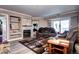 Relaxing living area with fireplace and built-in shelving, flowing into a cozy seating area with ample lighting at 12183 W Cross Dr # 202, Littleton, CO 80127