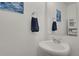 Powder room featuring a modern vanity, towel hanger and neutral walls at 18233 E 51St Ave, Denver, CO 80249