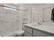 Contemporary bathroom design featuring a glass shower, a vanity with storage, and modern fixtures at 18233 E 51St Ave, Denver, CO 80249