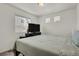Bright bedroom featuring lots of windows, a mounted tv, and a simple bedroom setup at 18233 E 51St Ave, Denver, CO 80249