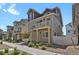 Charming multi-level townhome with balconies, neutral siding, and landscaped front yard at 18233 E 51St Ave, Denver, CO 80249