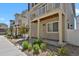 Inviting townhome exterior with charming porch, stone landscaping, and well-maintained yard at 18233 E 51St Ave, Denver, CO 80249
