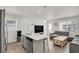 Bright living space with a modern kitchen island, stainless appliances, and comfortable seating at 18233 E 51St Ave, Denver, CO 80249